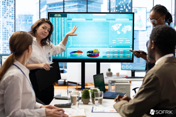 Business team working on screens with analytics